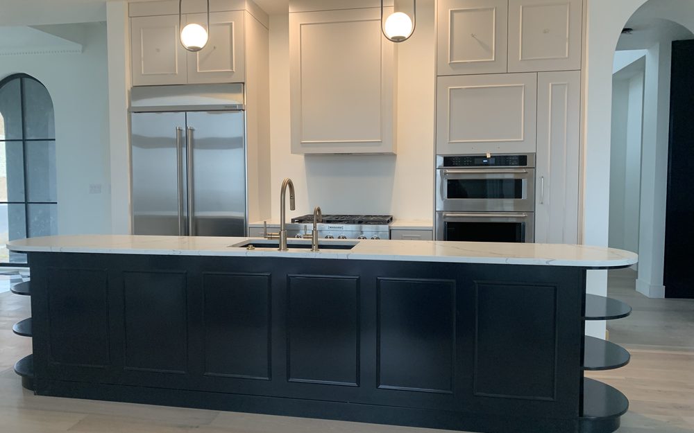 Modern kitchen with dark lower cabinets and white counters