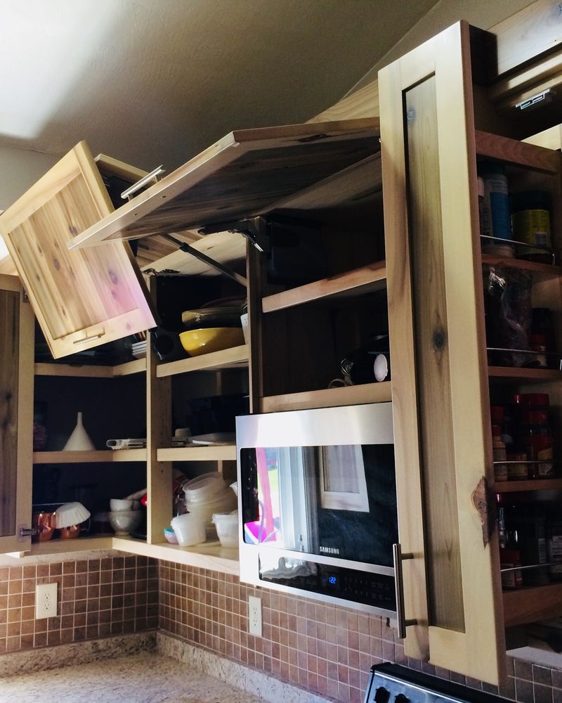 Open kitchen cabinetry showing wood cabinet interiors and pull-out storage