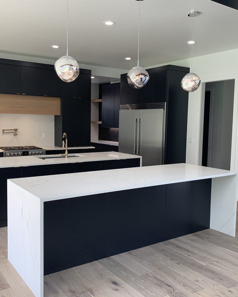 Contemporary kitchen cabinets around a white island
