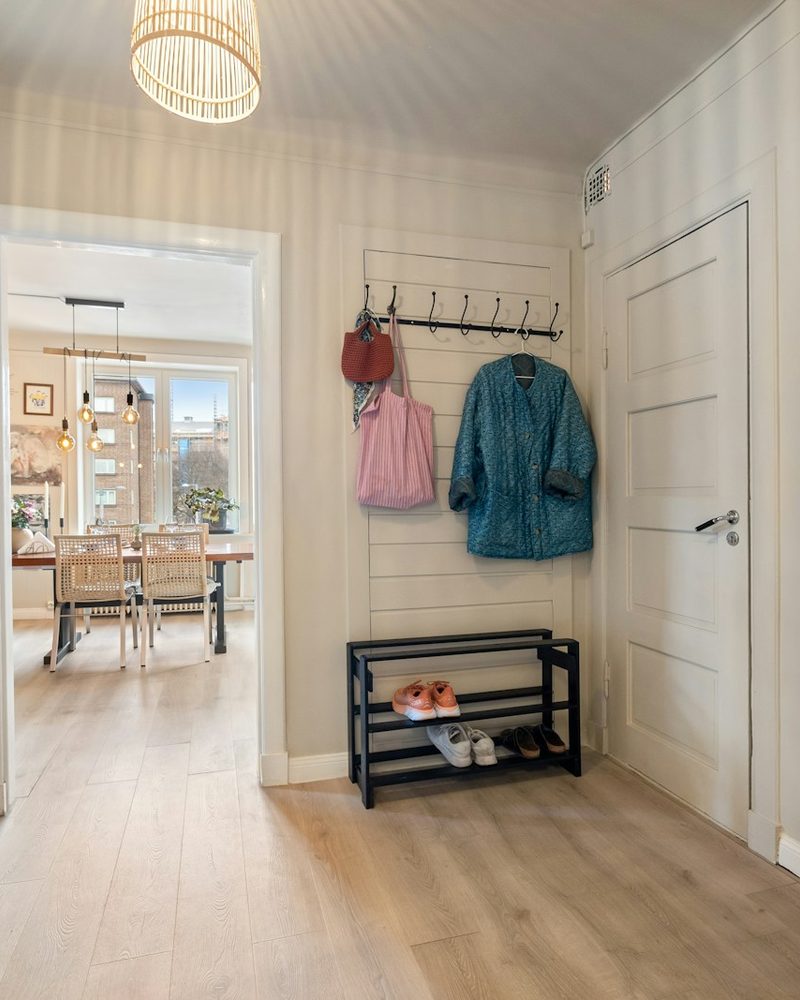 Hallway with coat hooks, shoe rack, and entry bench